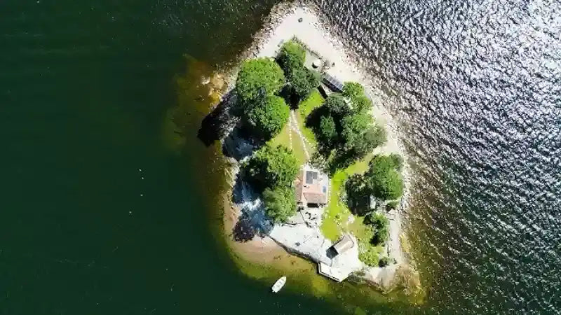 Island with a house and trees.