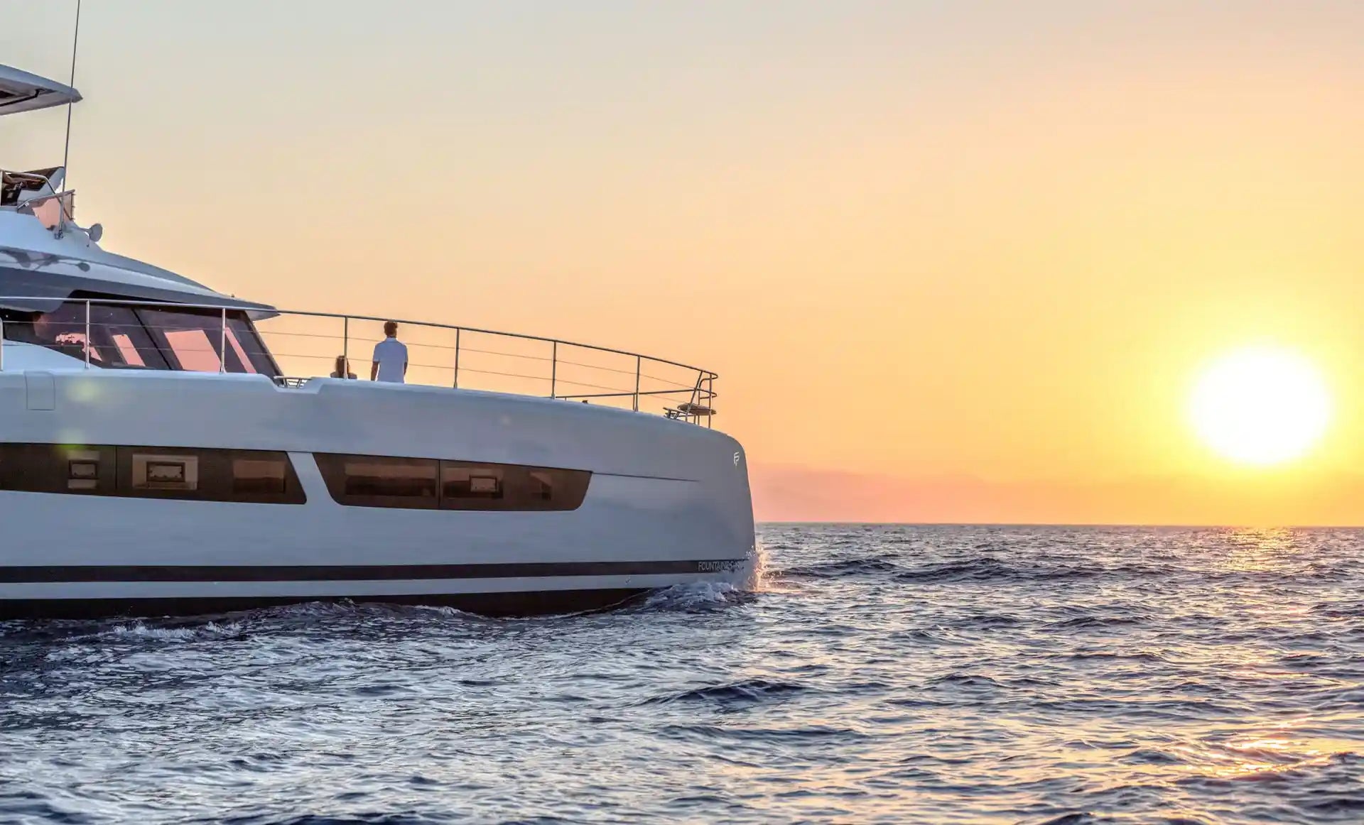 white super yacht boat with a sunset background