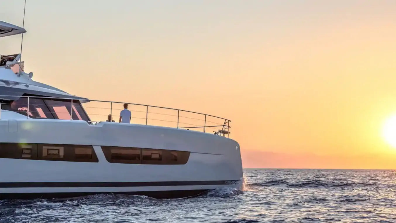 white super yacht boat with a sunset background